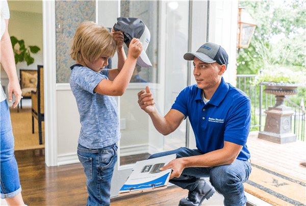 Technician giving a cap to a kid